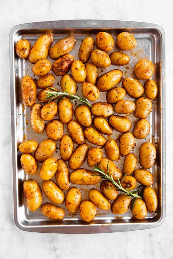 raw baby potatoes on silver sheet pan