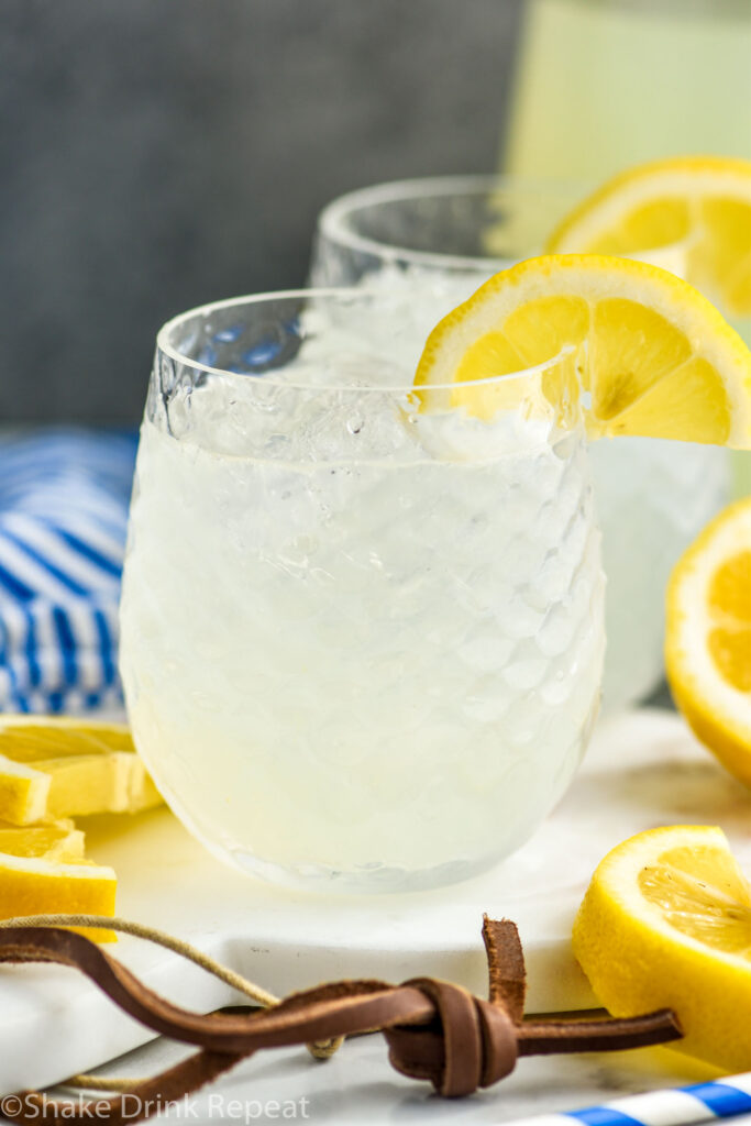 two glasses of vodka lemonade with ice and slices of lemon