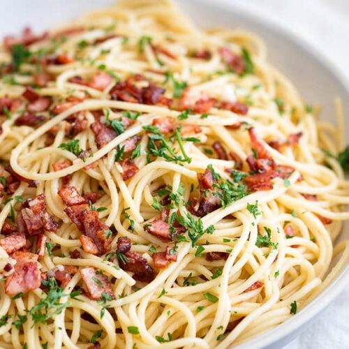 Garlic bacon spaghetti in a large shallow grey bowl