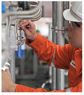 Engineer inspecting a tube fitting