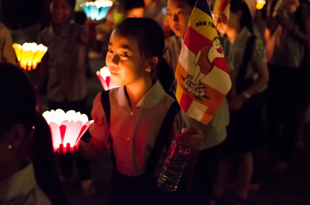 Girl with lantern at a procession during the Lantern Festival in Hoi An