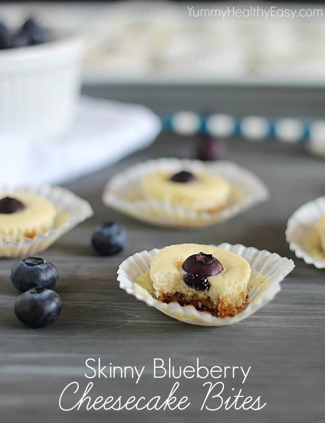 These Skinny Blueberry Cheesecake Bites have a crunchy crust and smooth cheesecake filling with a blueberry placed right in the center. When you bite into the middle, the blueberry explodes and almost makes a little jam topping. It is SO good! #blueberry #cheesecake #fingerfood #dessert #dessertrecipe via @jennikolaus